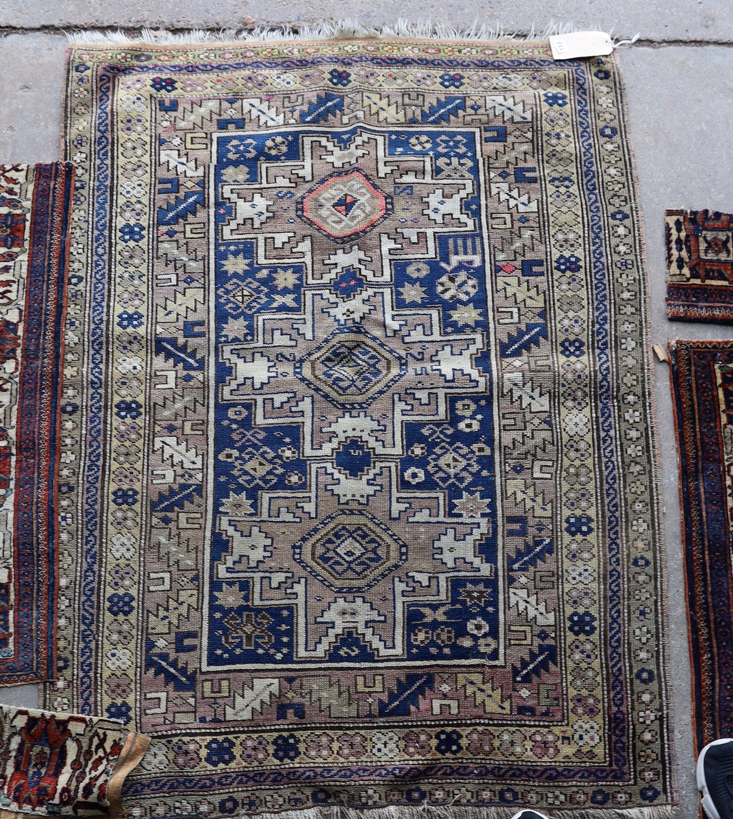 An antique Caucasian Derbend rug, 160 x 108cm, a smaller red ground rug and rug fragments